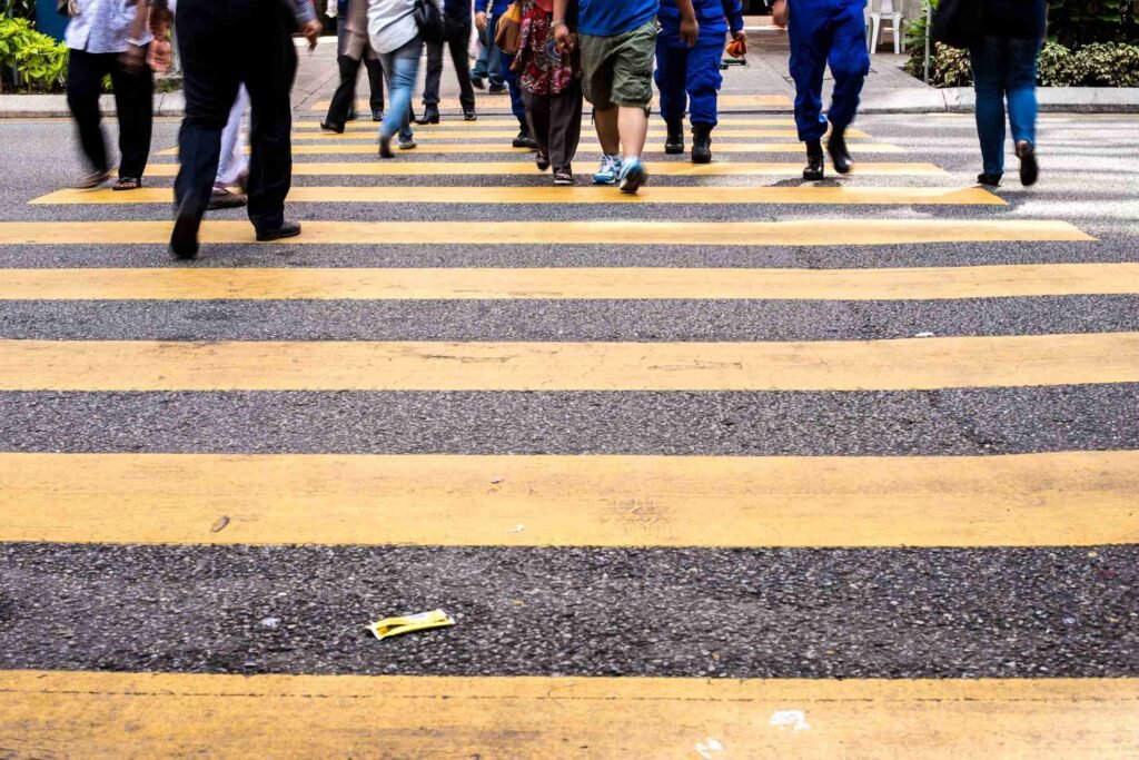 a group of pedestrians crossing the road